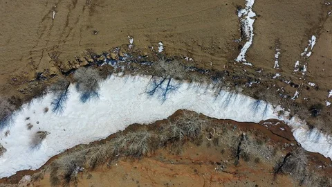 Aerial video from drone over frozen Kyzyl Chin river under ice. Stock Footage