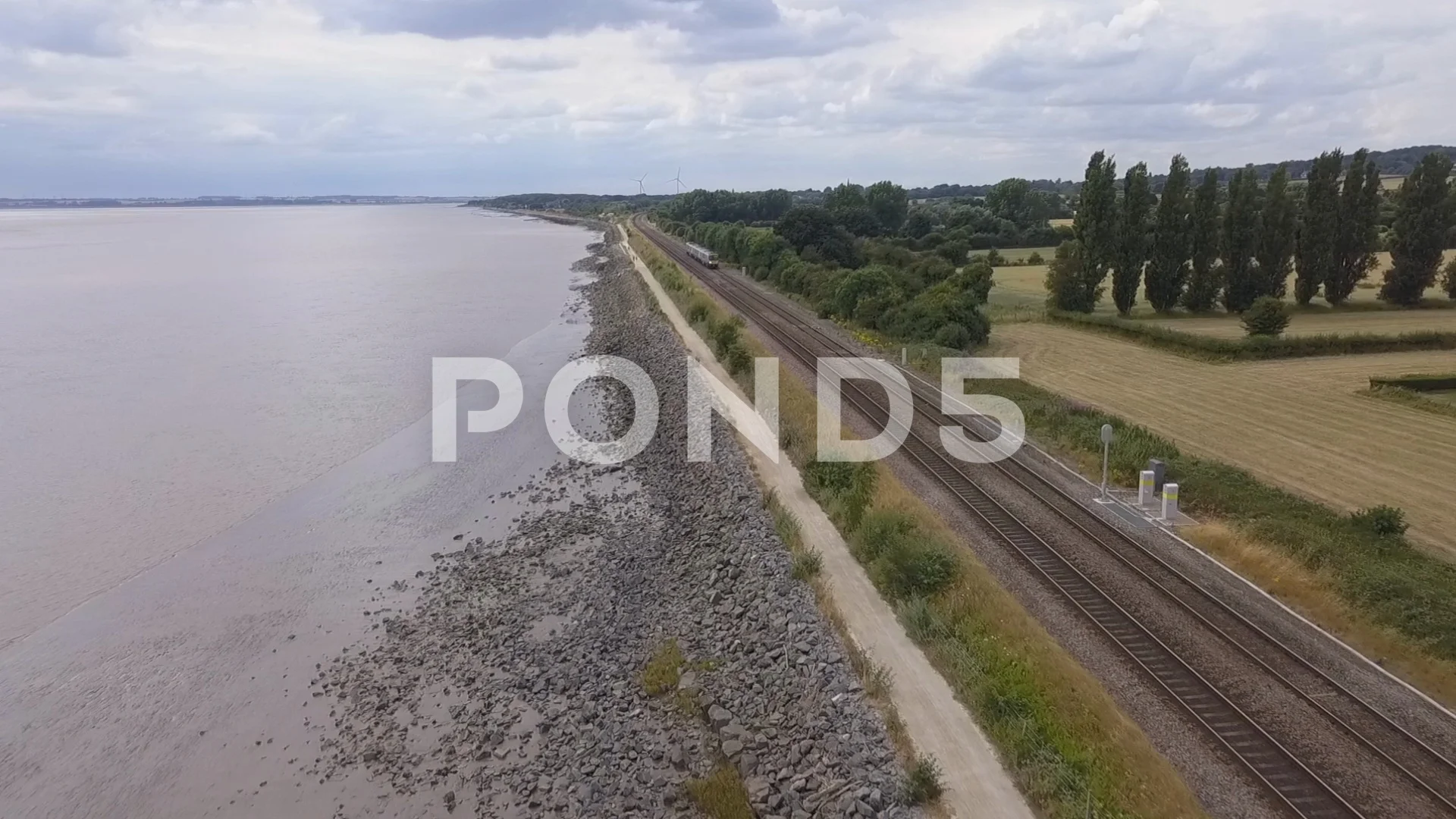 AERIAL VIDEO by drone of train running along the railway line parallel with  the