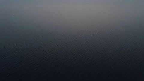 Aerial video of endless, blue, empty sea or ocean water surface at sunset. Shot Stock Footage 122512262