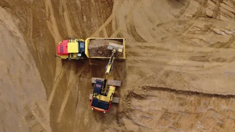 Aerial video of excavator digger loading sand truck at construction site Video stock 159952901