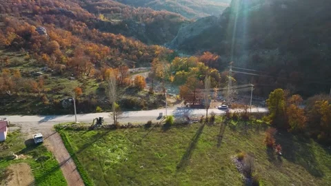 Aerial Video of Fall Trees Surrounding a Mountain Road Stock Footage 337640176