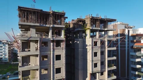 Aerial Video of a High-Rise Development With Cranes Moving Heavy Equipment and Stock-Footage 301366910