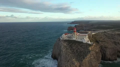 Aerial video of the lighthouse and cliffs at Cape St. Vincent. The sea view of Stock Footage 261373078
