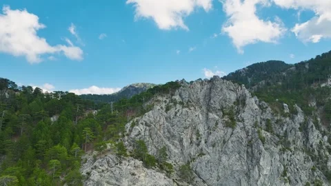 Aerial Video of Mountain Road Between Rocks and Pines 4K Drone Stock Footage 334114461