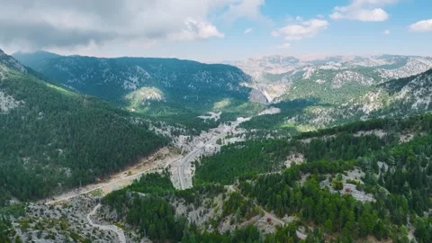 Aerial Video of Mountain Road on Cliffside by Forest Stock Footage 334114859