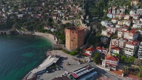 Aerial Video of the Red Tower Surrounded by an Azure Bay With a Small Marina and Stock Footage 301365112
