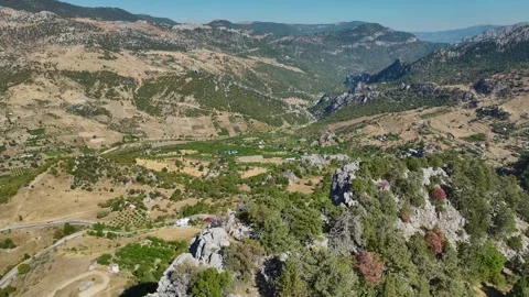 Aerial Video of Rugged Mountain Formations in Valley Stock Footage 334113029