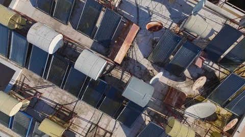 Aerial Video of a Rustic Home Featuring Solar Panels and Water Storage Barrels Stock Footage 301382446