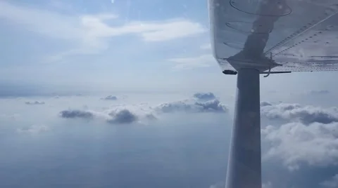 Aerial video from a small plane window while flying over beautiful clouds. Stock Footage 58054153