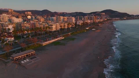 Aerial Video of Sunset Over Waves Touching Sandy Beach 库存影片 343587341