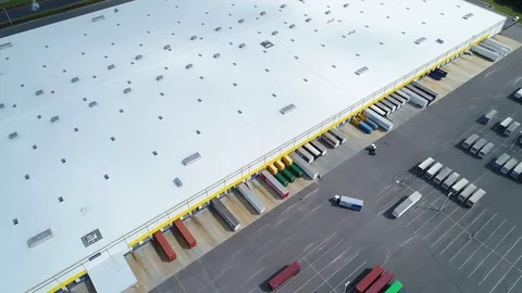 Aerial video truck loading docks at a shipping warehouse 4k drone Stock Footage 77320208