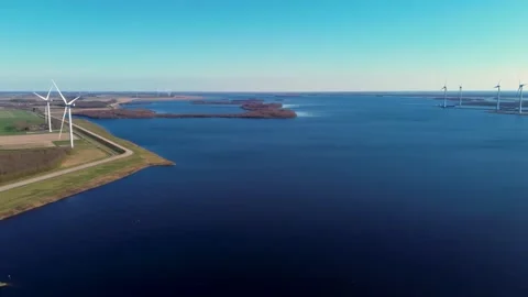 Aerial video of a vast blue sea with small islands curved shoreline and wind Stock-Footage 304673853