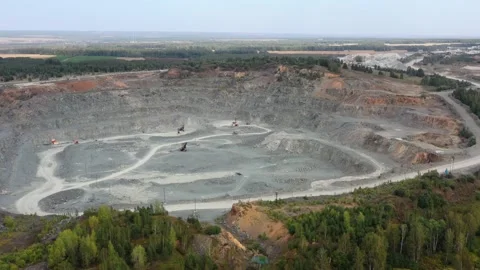 Aerial video view of mining quarry. Excavator loads rock in a dump truck Stock Footage 130558632