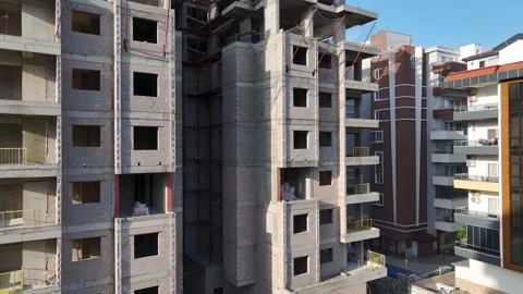 Aerial Video Workers build the upper floor of a structure, installing metal Stock Footage 343901961