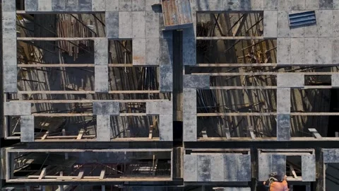 Aerial Video Workers handle metal and concrete on a new floor, reinforcing the Stock Footage 343902884