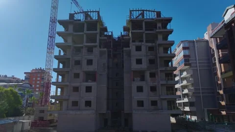 Aerial Video: Workers Operating Cranes and Handling Heavy Materials on a Large Stock Footage 342503831