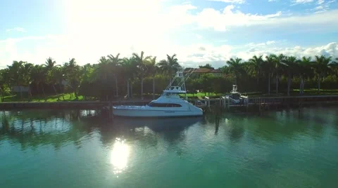 Aerial video of a yacht and luxury mansions Stock Footage