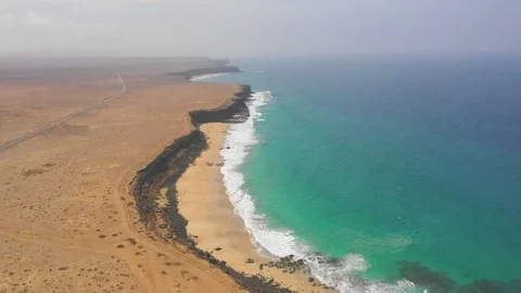 Aerial View 2 Of Ocean Waves and rock of Cotillo in Fuerteventura island Stock Footage 119588446