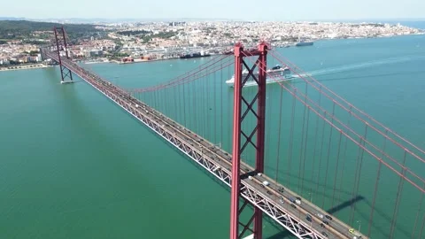 An aerial view of the 25 de Abril Bridge with a cruise ship Stock Footage 202014736