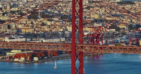 Aerial view of 25 de Abril bridge over the Tagus River at sunset in Lisbon Stockbeeldmateriaal 310203231