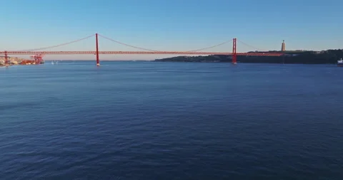 Aerial view of 25 de Abril bridge over the Tagus River at sunset in Lisbon Stock Footage 310679113