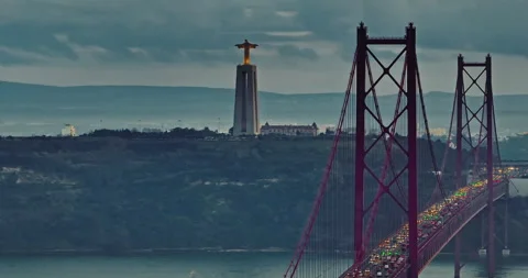 Aerial view of 25 de Abril bridge over the Tagus River at sunset in Lisbon Stock Footage 316045532