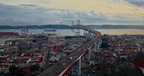 Aerial view of 25 de Abril bridge over the Tagus River at sunset in Lisbon Stock-Footage 317540763