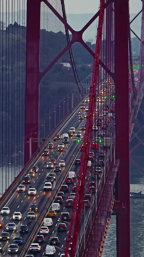 Aerial view of 25 de Abril bridge over the Tagus River at sunset in Lisbon Stock Footage 318598938