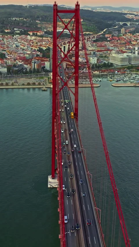 Aerial view of 25 de Abril bridge over the Tagus River at sunset in Lisbon 動画素材 319965161