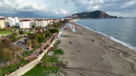 Aerial view 4 K parachute jumper flying over beautiful Alanya Stock Footage 224001704