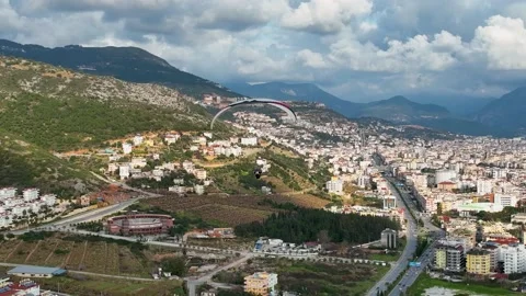 Aerial view 4 K parachute jumper flying over beautiful Alanya Stock Footage 224003322