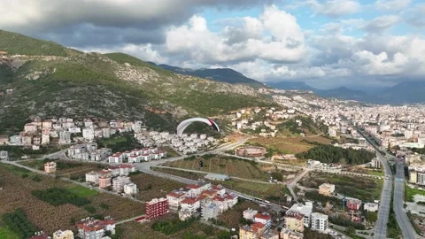 Aerial view 4 K parachute jumper flying over beautiful Alanya Stock Footage 224006317