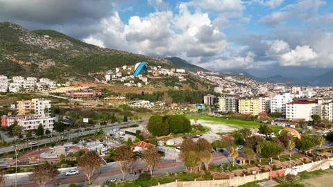 Aerial view 4 K parachute jumper flying over beautiful Alanya Stock Footage 224006624