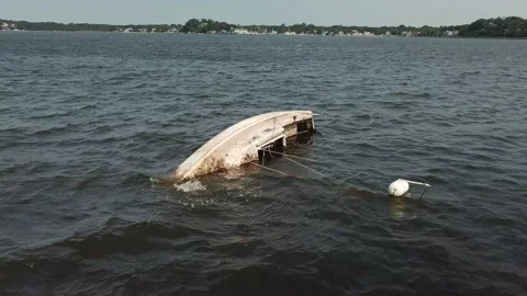 Aerial View 4K - Capsized Sailboat - Right Rotate Close Stock Footage 138183553