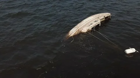 Aerial View 4K - Capsized Sailboat - Low Altitude Right Flyby Stock Footage 138183643