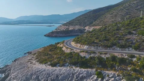 Aerial View 4K: Couple s Scenic Drive by the Mediterranean Sea in a Convertible Stock Footage 344240780