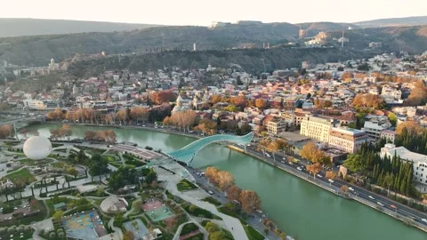 Aerial View 4K: Dawn Over Tbilisi - The Citys Morning Glow Unveiled Stock Footage 293574607