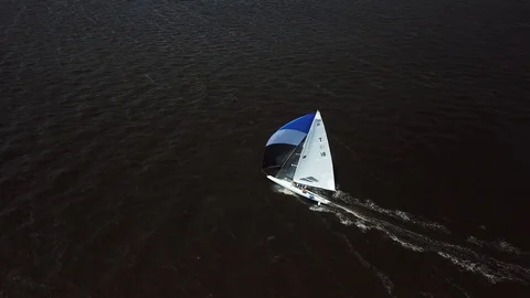 Aerial View 4K - E Scow Sailboat Sailing Fast Downwind (BBYRA T18) - Follow Stock Footage 113144860
