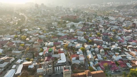Aerial View 4K: First Light in Tbilisi - A Mesmerizing Urban Panorama Stock Footage 293576123