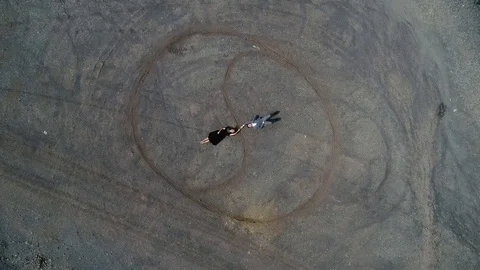 Aerial view . 4k. Fly over man and woman dressed in retro clothes and lying on Stock Footage 101791134
