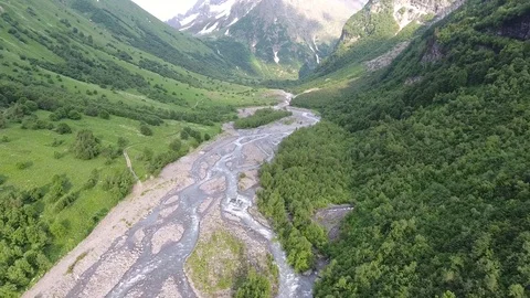 Aerial view .4K flying over the river to the mountains Stock Footage 73299943
