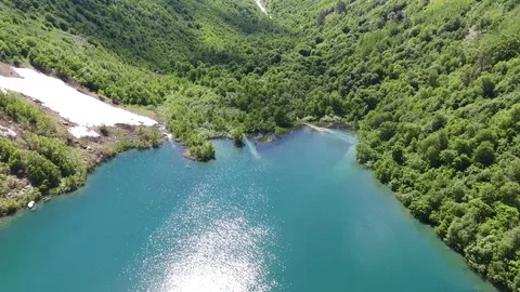 Aerial View. 4к Flying over the beautiful lake near mountains Stock Footage 73336002