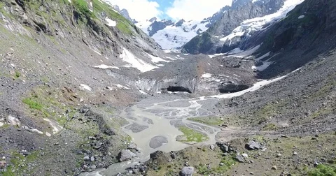 Aerial View. 4K flying over the mountain stream to the glacier Stockbeeldmateriaal 73384843