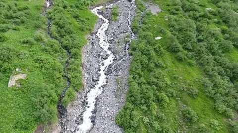 Aerial view .4K flying over a mountain stream Stock Footage 73601002