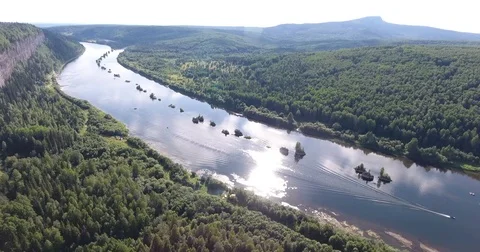 Aerial view. 4K flying over the river, forest and cliffs . The boat floats on Stockbeeldmateriaal 73873238