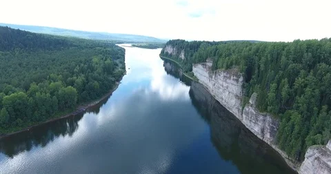 Aerial view. 4K flying over the river, forest and cliffs . Tourist camp near the Stock Footage 73873541
