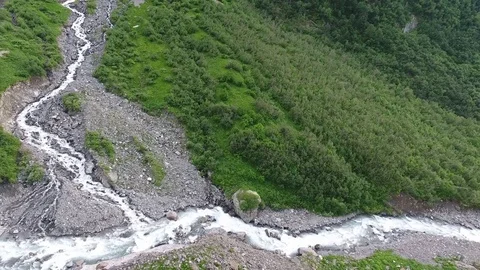 Aerial view .4K flying over a mountain stream Stock Footage 73935973