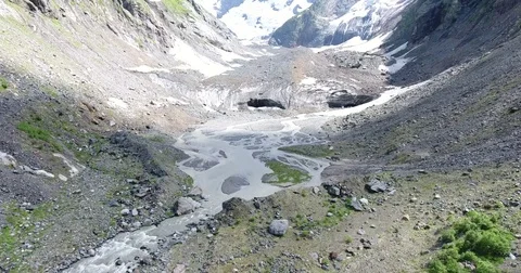 Aerial View. 4K flying over the mountain stream to the glacier Stockbeeldmateriaal 73984597