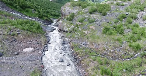 Aerial view .4K flying over a mountain stream Stockbeeldmateriaal 73984684