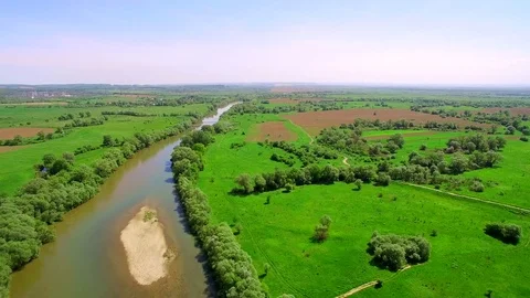 Aerial View 4k. Flying over the beautiful River. Aerial camera shot. Landscape Stock Footage 77047189